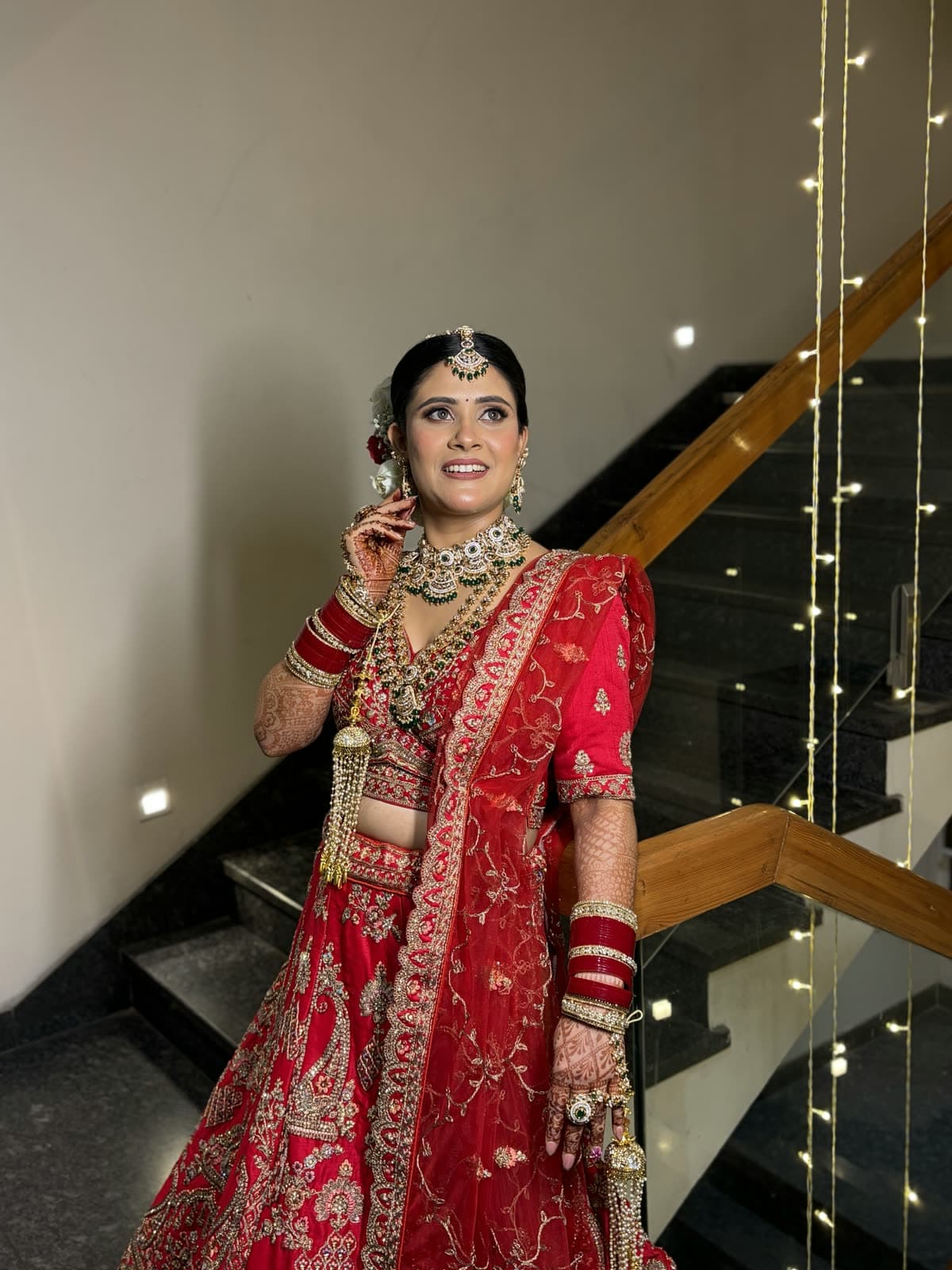 Shilpa in a red bridal lehenga with softly defined makeup